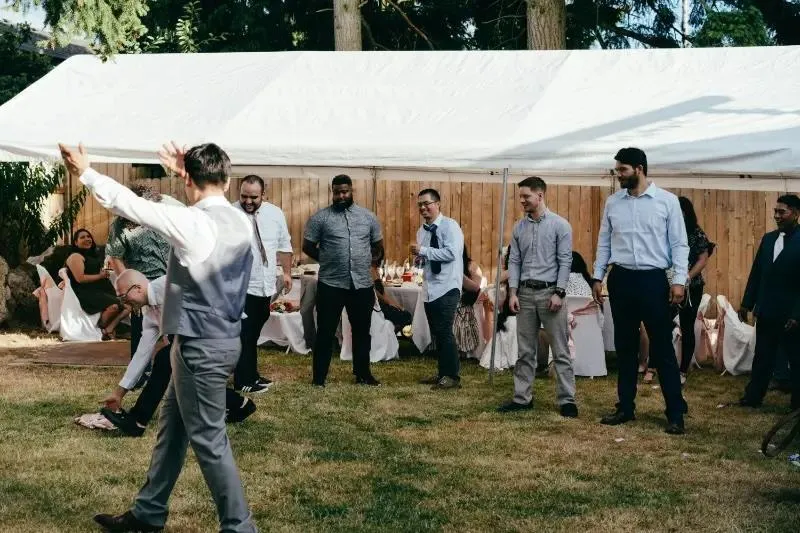 Guests dancing on the lawn by a marquee