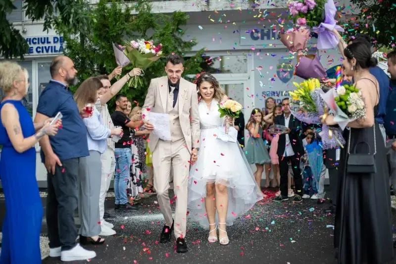 Newlyweds walking through cheering guests